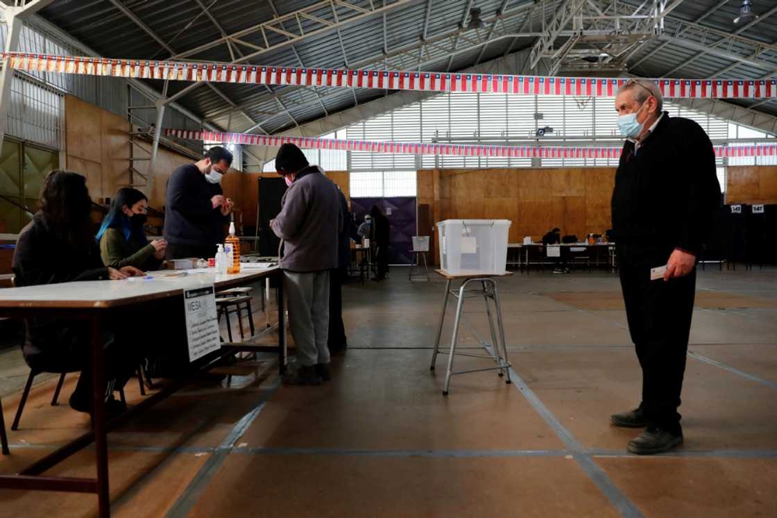 A man waits in line to cast his vote during a referendum to approve or reject a new Constitution at a polling station in Santiago A man waits in line to cast his vote during a referendum to approve or reject a new Constitution at a polling station in Santiago