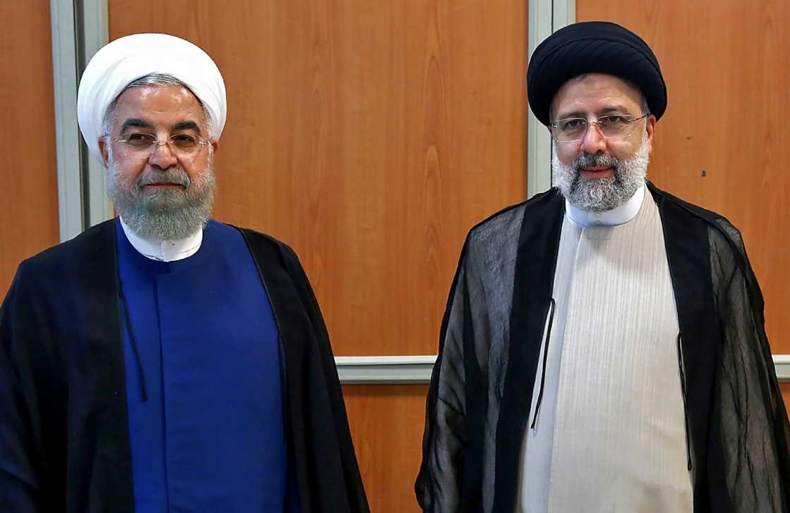 After the 2018-2019 recession, Iran had returned to economic growth under Rouhani, pictured standing on the left next to Raisi in this file photo After the 2018-2019 recession, Iran had returned to economic growth under Rouhani, pictured standing on the left next to Raisi in this file photo