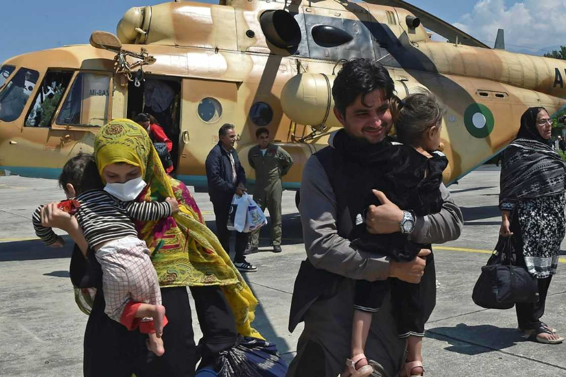 A Pakistani family leaves an army rescue helicopter in Swat after being rescued from a cut off valley A Pakistani family leaves an army rescue helicopter in Swat after being rescued from a cut off valley