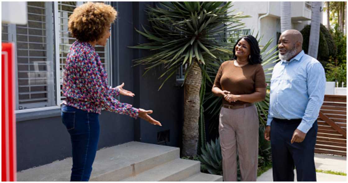 A couple meet with a real estate agent A couple meet with a real estate agent