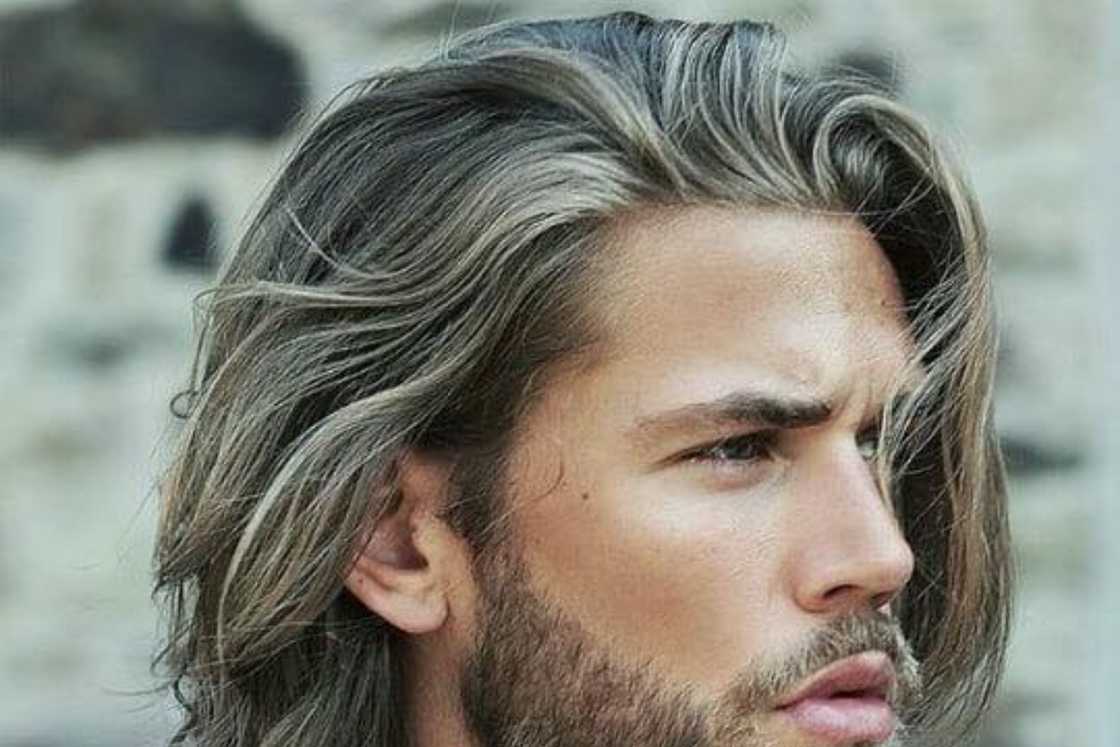 A man is rocking a textured layered hairstyle A man is rocking a textured layered hairstyle