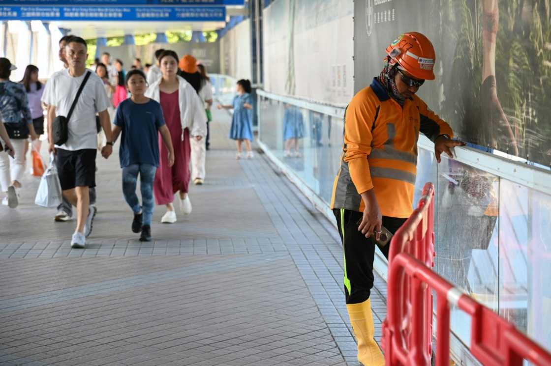 A Hong Kong construction worker (R) takes a break from the heat A Hong Kong construction worker (R) takes a break from the heat