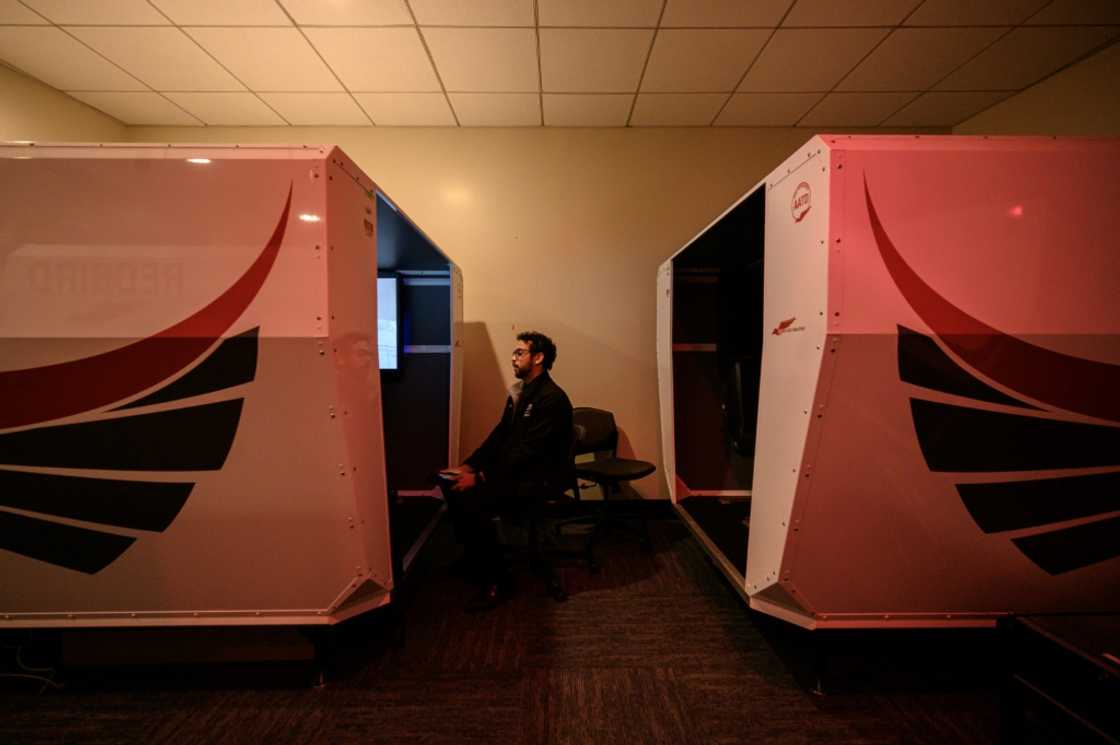 An instructor watches as a student pilot undergoes a training session in a flight simulator at the Farmingdale State College in Farmingdale, New York An instructor watches as a student pilot undergoes a training session in a flight simulator at the Farmingdale State College in Farmingdale, New York
