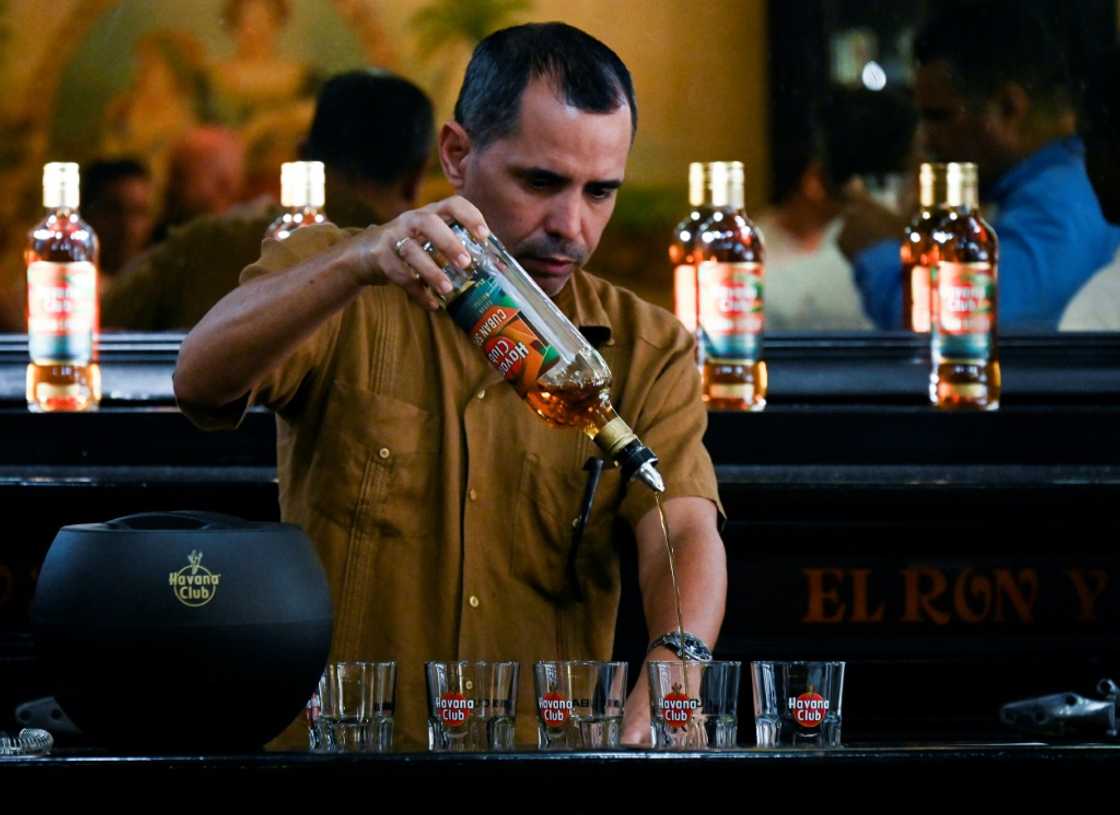 A bartender serves the new Havana Club Cuban Spiced rum at Havana's rum museum on November 15, 2022 A bartender serves the new Havana Club Cuban Spiced rum at Havana's rum museum on November 15, 2022