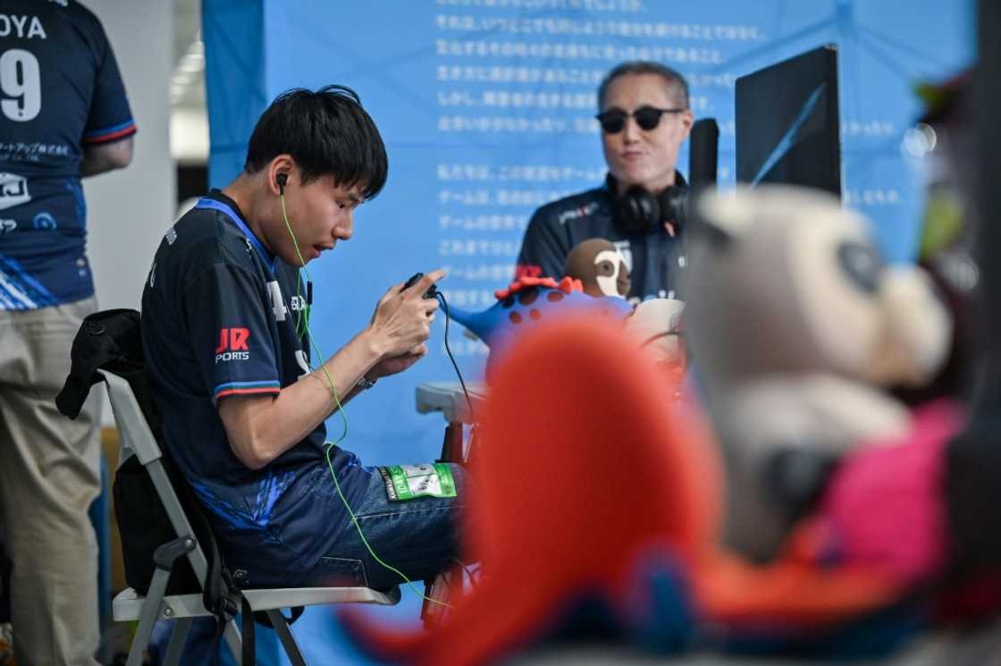 Blind eSports player Masahiro Fujimoto (L), who goes by "Mashiro", hopes that AI could help him travel alone Blind eSports player Masahiro Fujimoto (L), who goes by "Mashiro", hopes that AI could help him travel alone