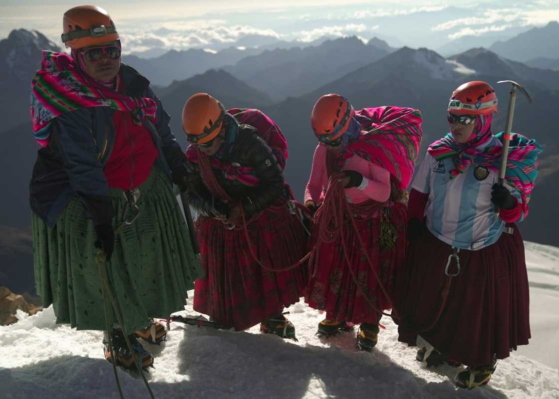 (Left-right) Adela Llusco, Senobia Llusco, Cecilia Llusco and Camila Tarqui Llusco, Aymara indigenous women members of the Climbing Cholitas of Bolivia Warmis, at the summit of the 6.088-metre Huayna Potosi mountain (Left-right) Adela Llusco, Senobia Llusco, Cecilia Llusco and Camila Tarqui Llusco, Aymara indigenous women members of the Climbing Cholitas of Bolivia Warmis, at the summit of the 6.088-metre Huayna Potosi mountain