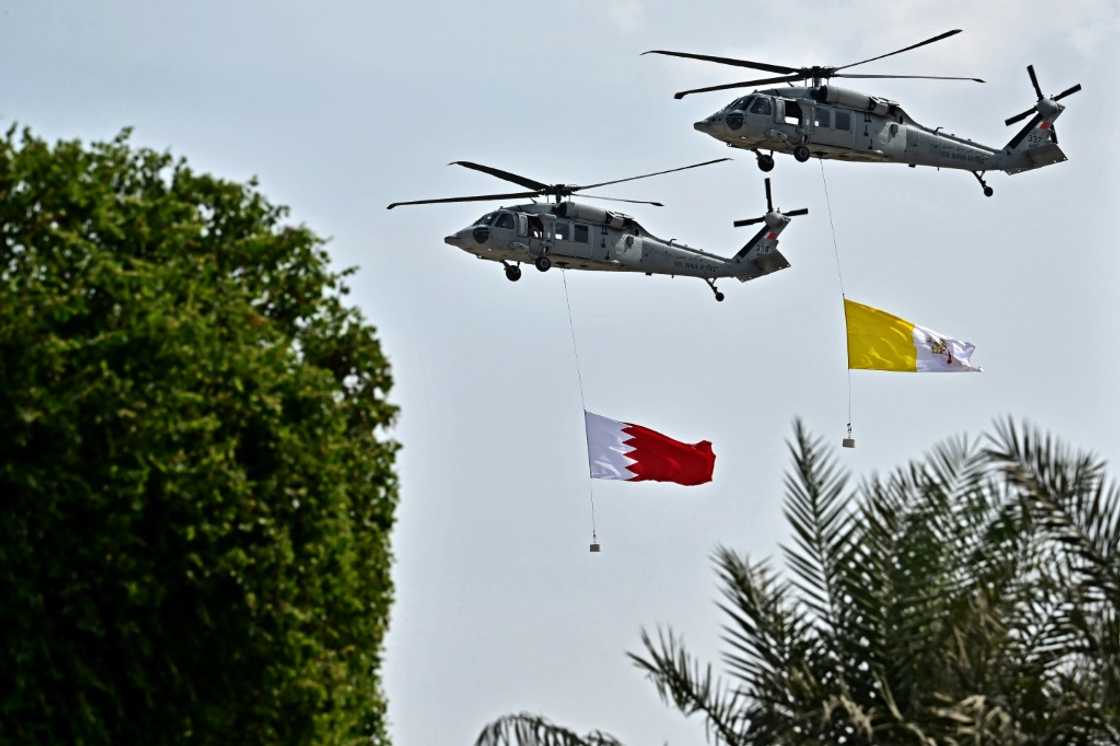 Helicopters of the Bahraini Royal Guard fly Bahrain and Vatican flags during a welcome ceremony at Sakhir Royal Palace Helicopters of the Bahraini Royal Guard fly Bahrain and Vatican flags during a welcome ceremony at Sakhir Royal Palace