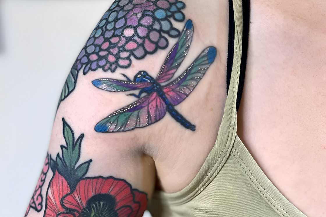 Dragonfly details with floral sleeve tattoo Dragonfly details with floral sleeve tattoo