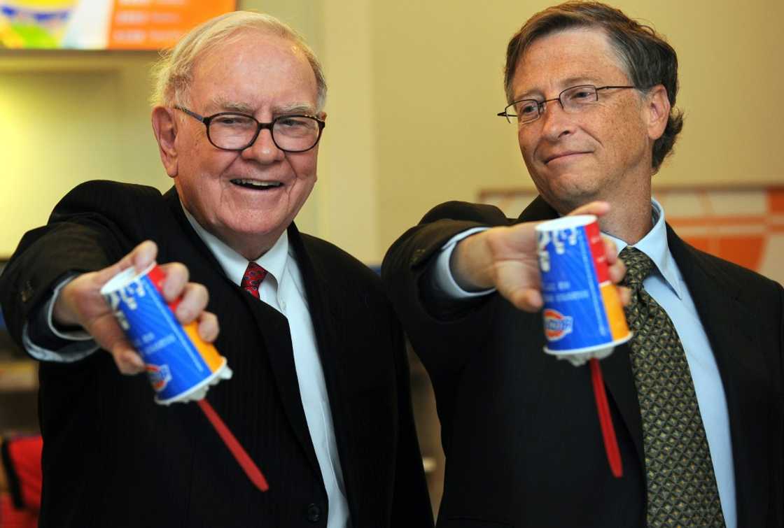 US billionaire investor Warren Buffett (L) and Microsoft founder Bill Gates (R) flip over their Dairy Queen Blizzard treats in Beijing in 2011; Dairy Queen is one of dozens of iconic brands owned by Buffett's Berkshire Hathaway US billionaire investor Warren Buffett (L) and Microsoft founder Bill Gates (R) flip over their Dairy Queen Blizzard treats in Beijing in 2011; Dairy Queen is one of dozens of iconic brands owned by Buffett's Berkshire Hathaway