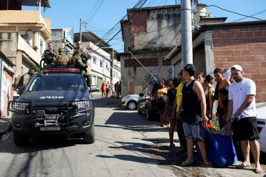 Residents of the Complexo do Alemao favela in Rio de Janeiro carry the body of a man who was killed in a police raid on July 21, 2022 Residents of the Complexo do Alemao favela in Rio de Janeiro carry the body of a man who was killed in a police raid on July 21, 2022