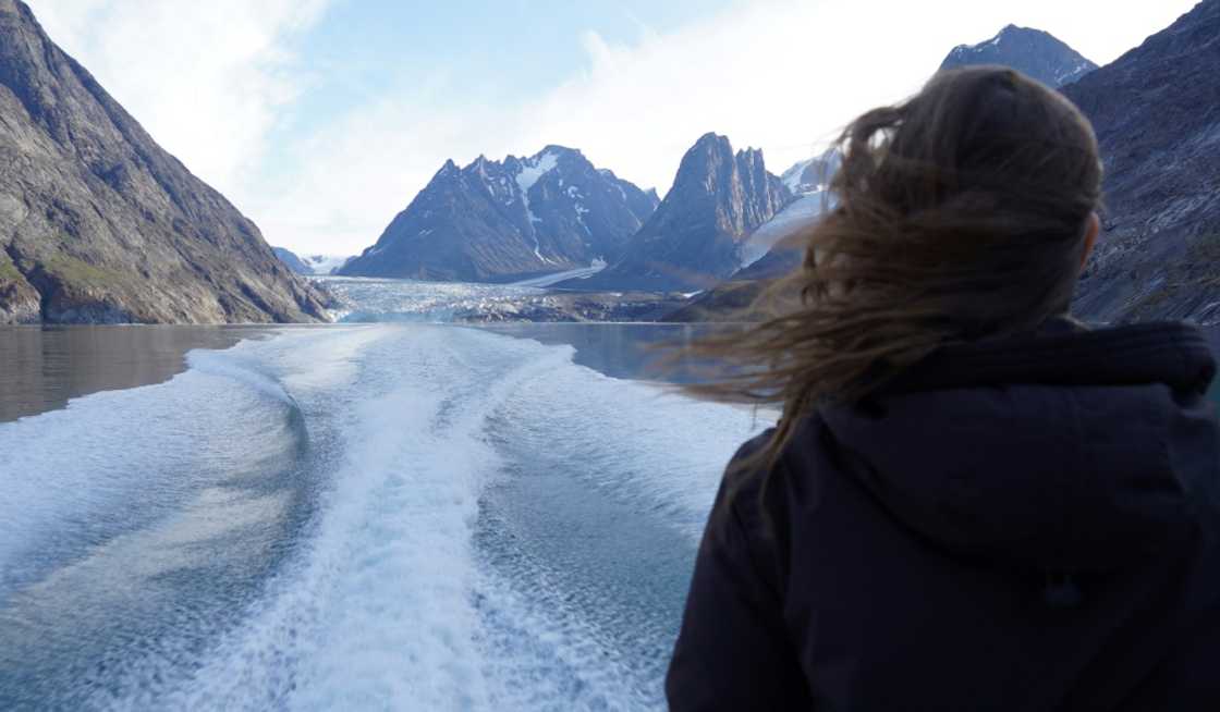 A woman looks out from a tour boat as it sails away from a glacier between Maniitsoq and Sisimiut in Greeceland A woman looks out from a tour boat as it sails away from a glacier between Maniitsoq and Sisimiut in Greeceland