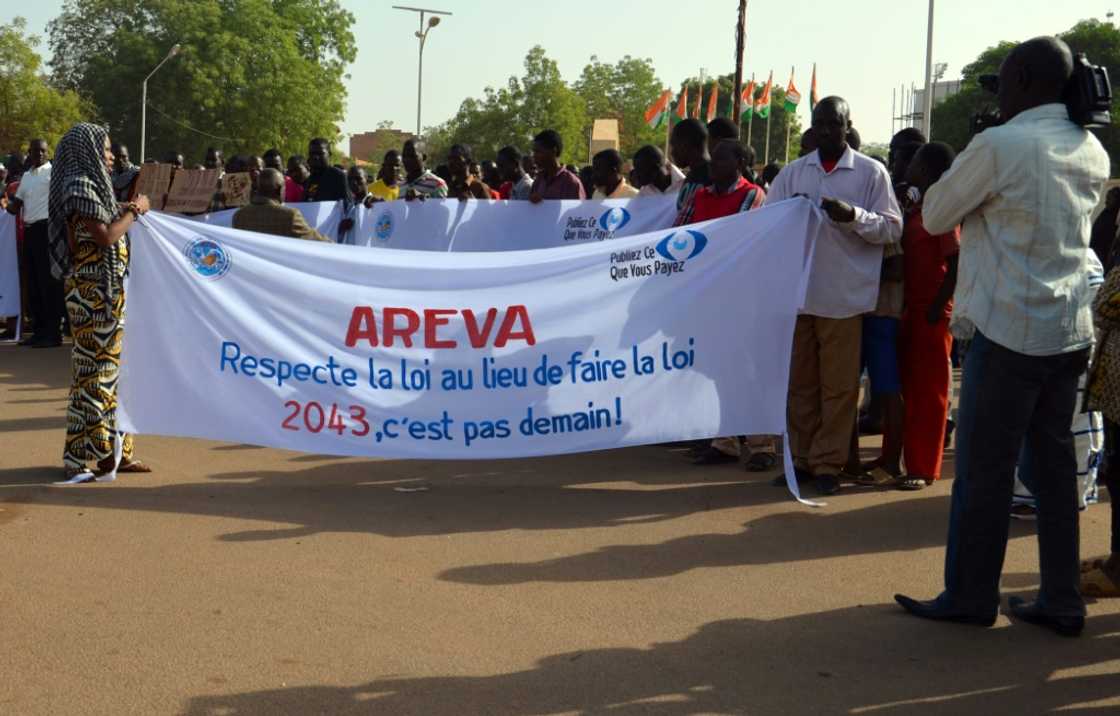 Protestors in Niamey in December 2013, at the height of contract negotiations between Areva and Niger. The sign reads: 'Areva, respect the law instead of making it' Protestors in Niamey in December 2013, at the height of contract negotiations between Areva and Niger. The sign reads: 'Areva, respect the law instead of making it'
