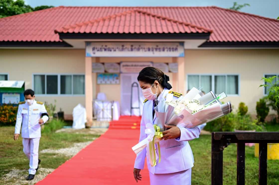 Officials prepare a red carpet leading to the nursery