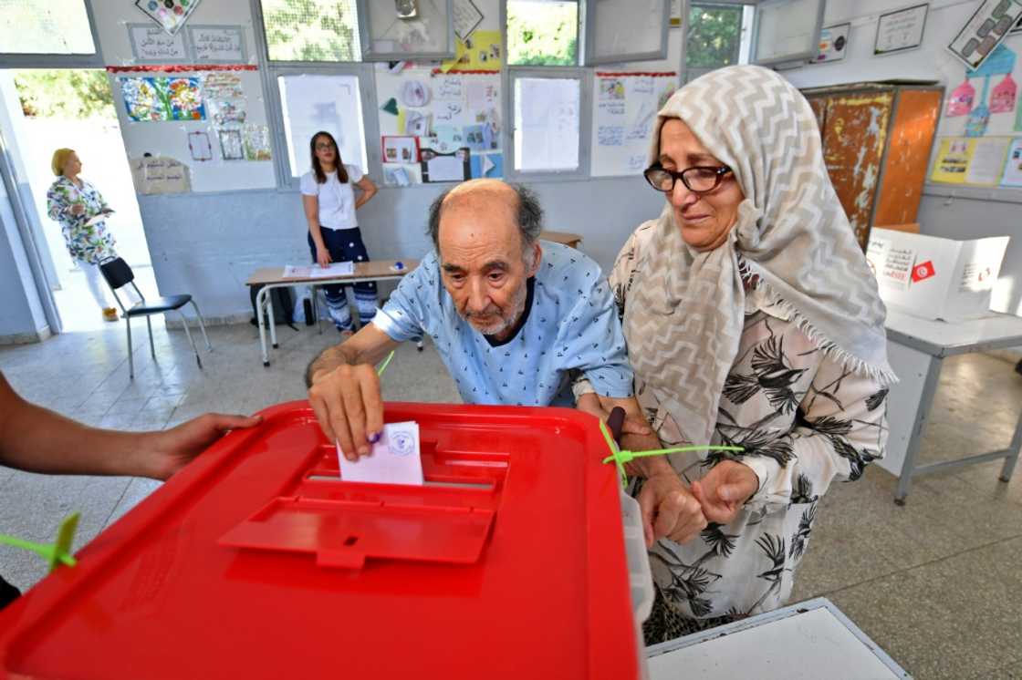An elderly Tunisian man arrives with his wife to vote in Tunis in a referendum on a draft constitution An elderly Tunisian man arrives with his wife to vote in Tunis in a referendum on a draft constitution
