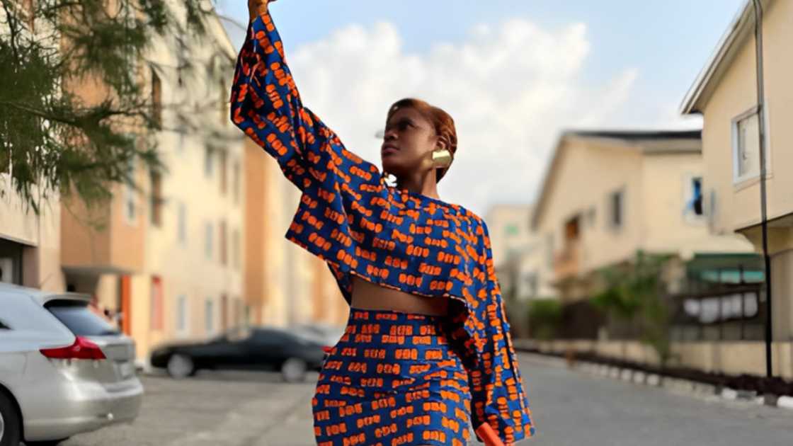 A lady is rocking a multi-coloured African print top with Ankara patterns