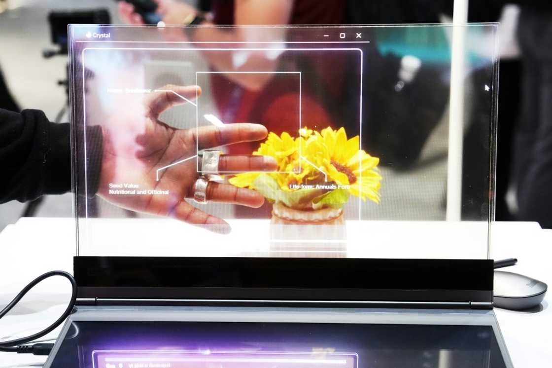 A visitor tests the transparent display of new Lenovo ThinkBook laptop on the first day of the Mobile World Congress (MWC) in Barcelona