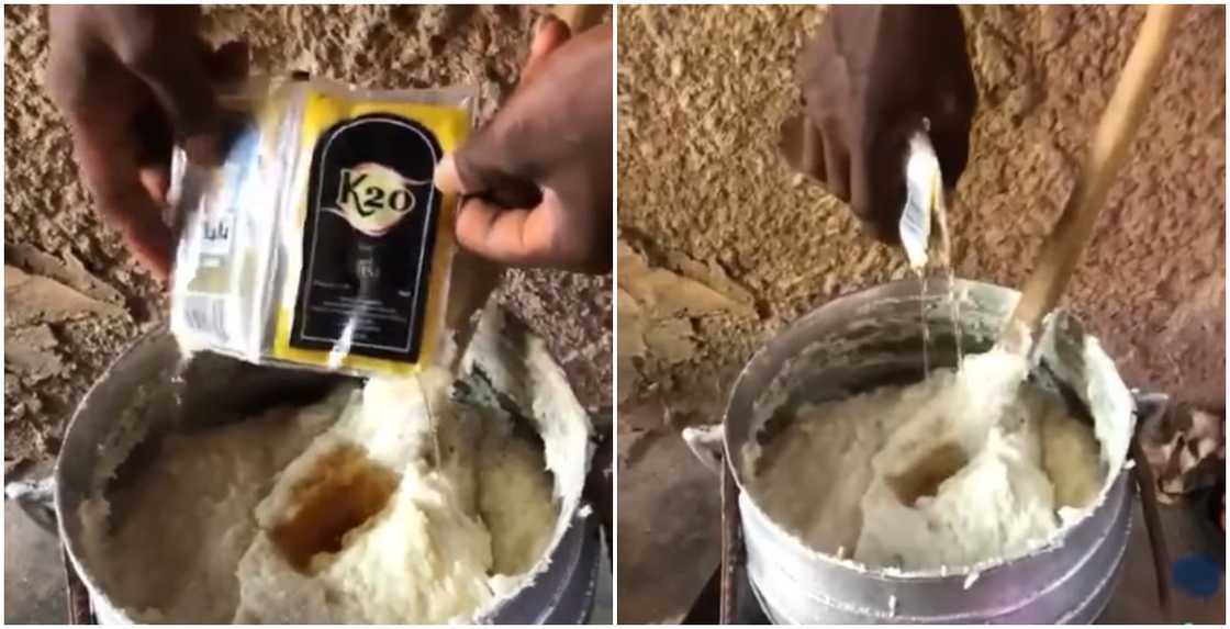 Man pouring whisky into banku on fire