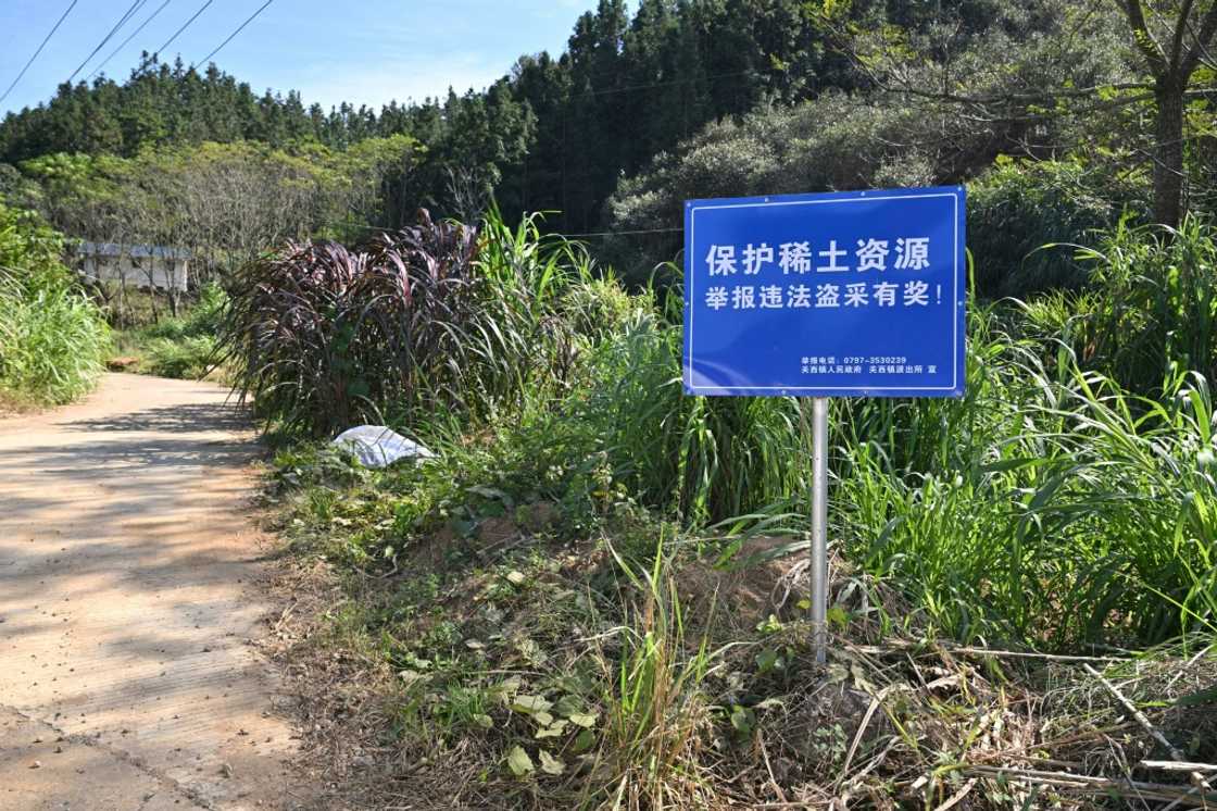 Signage announcing a reward for those who report illegal rare earth mining activities, in Dingnan County in eastern China Signage announcing a reward for those who report illegal rare earth mining activities, in Dingnan County in eastern China