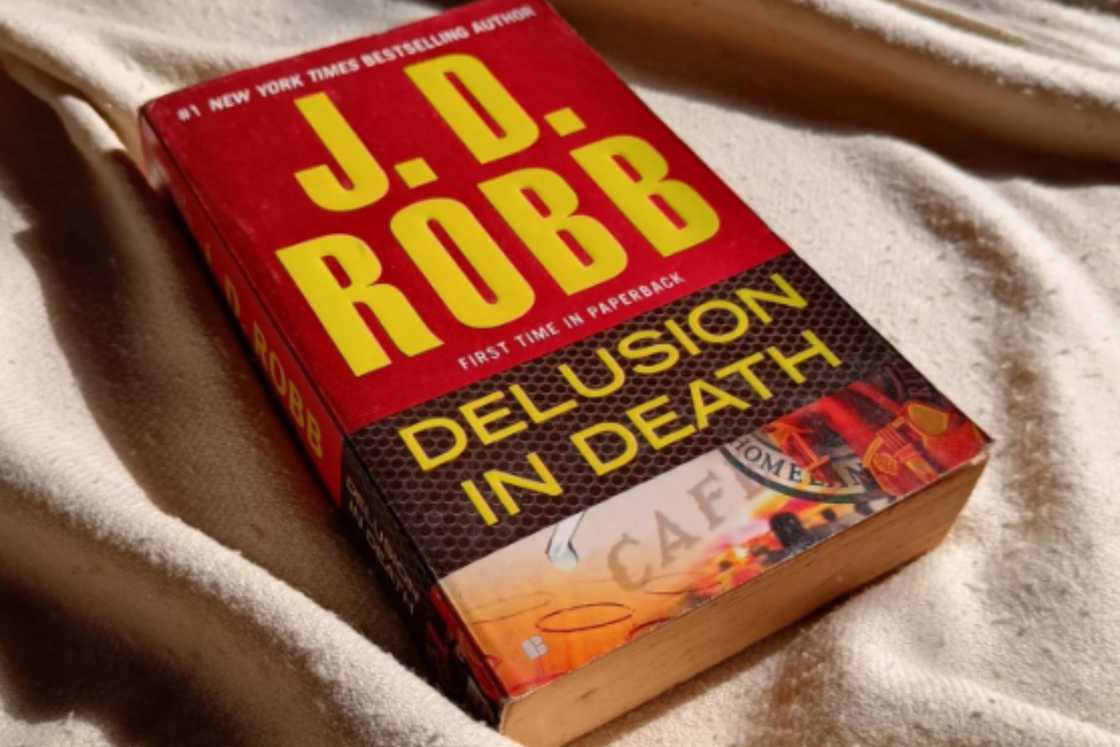 Delusion in Death book is on a bed