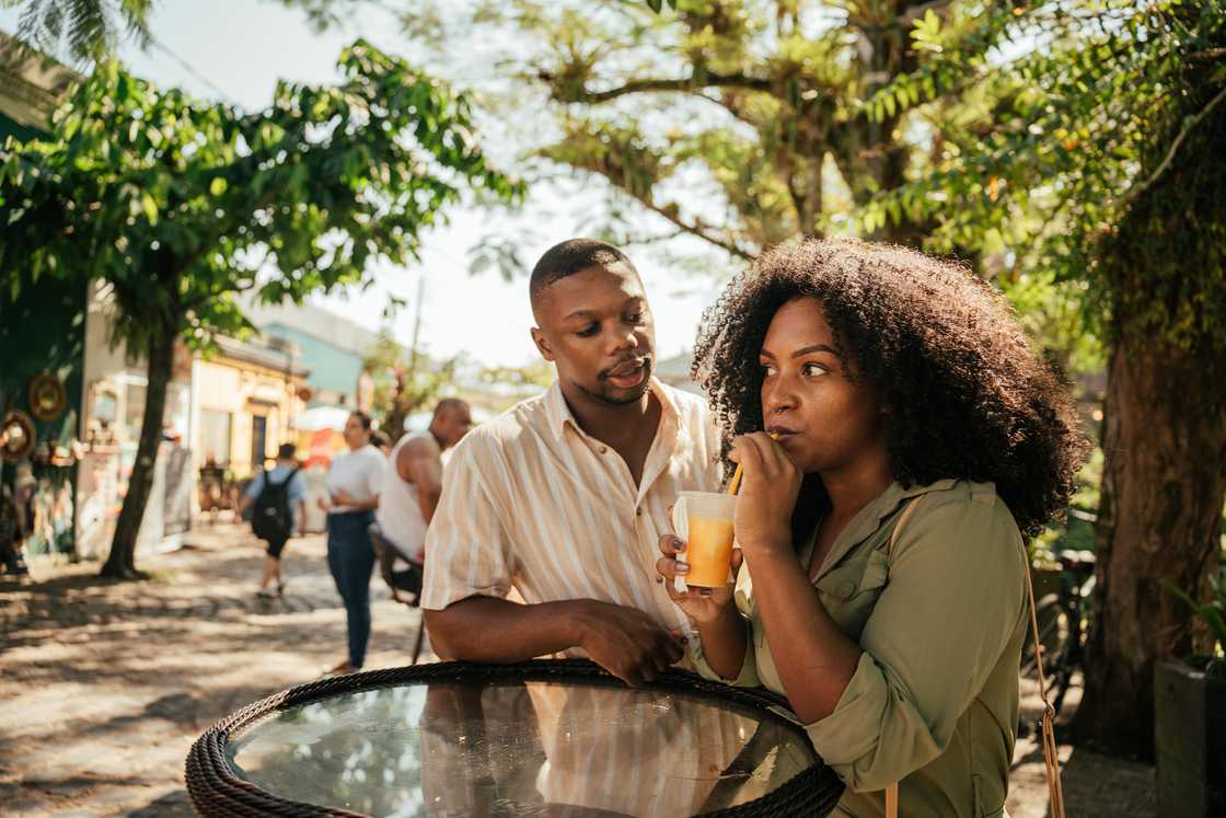 A woman sitting with a friend outdoors. A woman sitting with a friend outdoors.