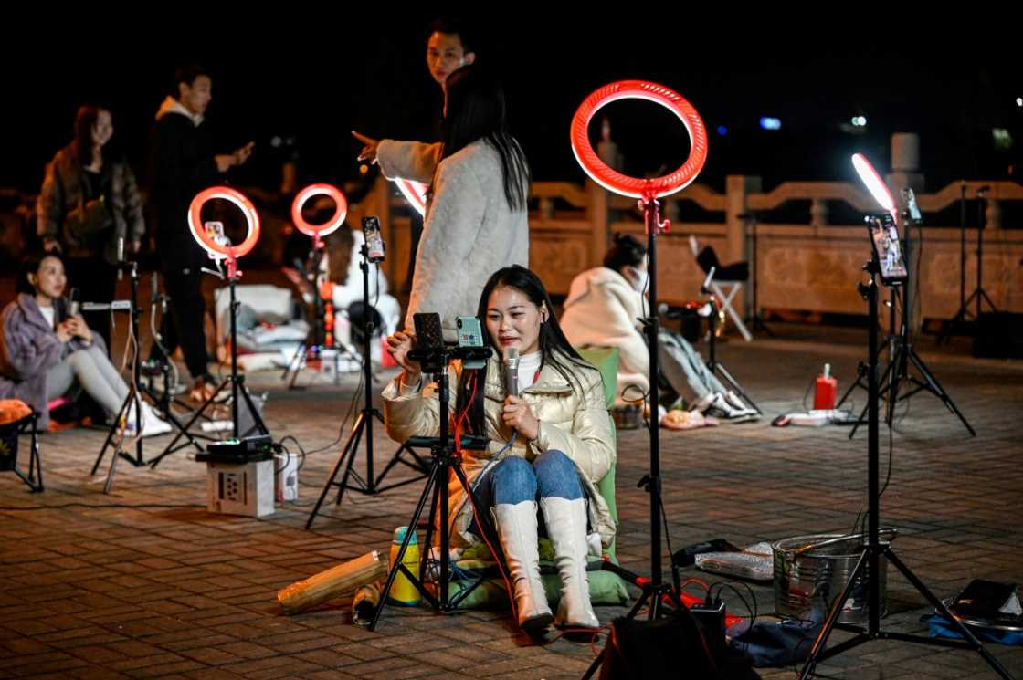 Livestreamers gather on a bridge in the Chinese city of Guilin in the hopes of catching the attention of Douyin users