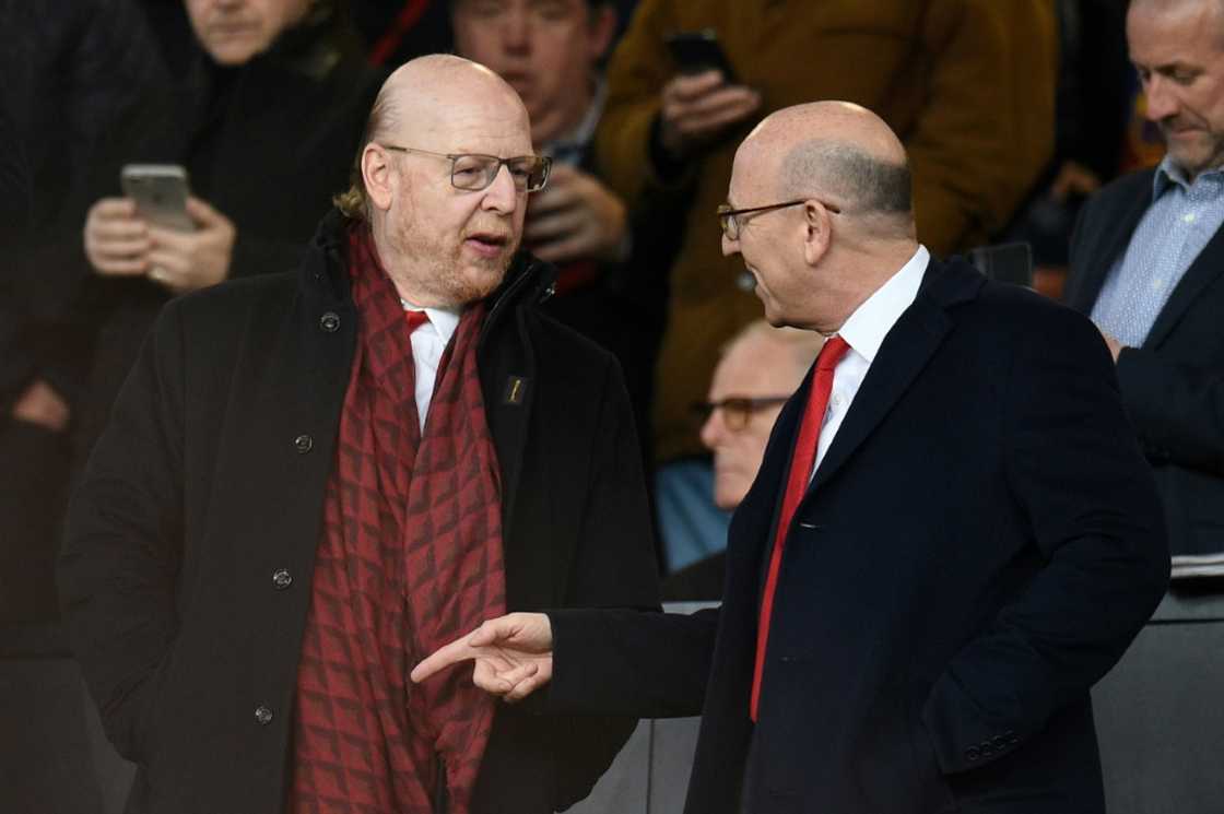 Manchester United owners Avram Glazer (L) and Joel Glazer