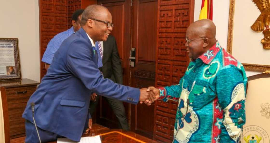 Addison shakes Akufo-Addo's hands. Addison shakes Akufo-Addo's hands.