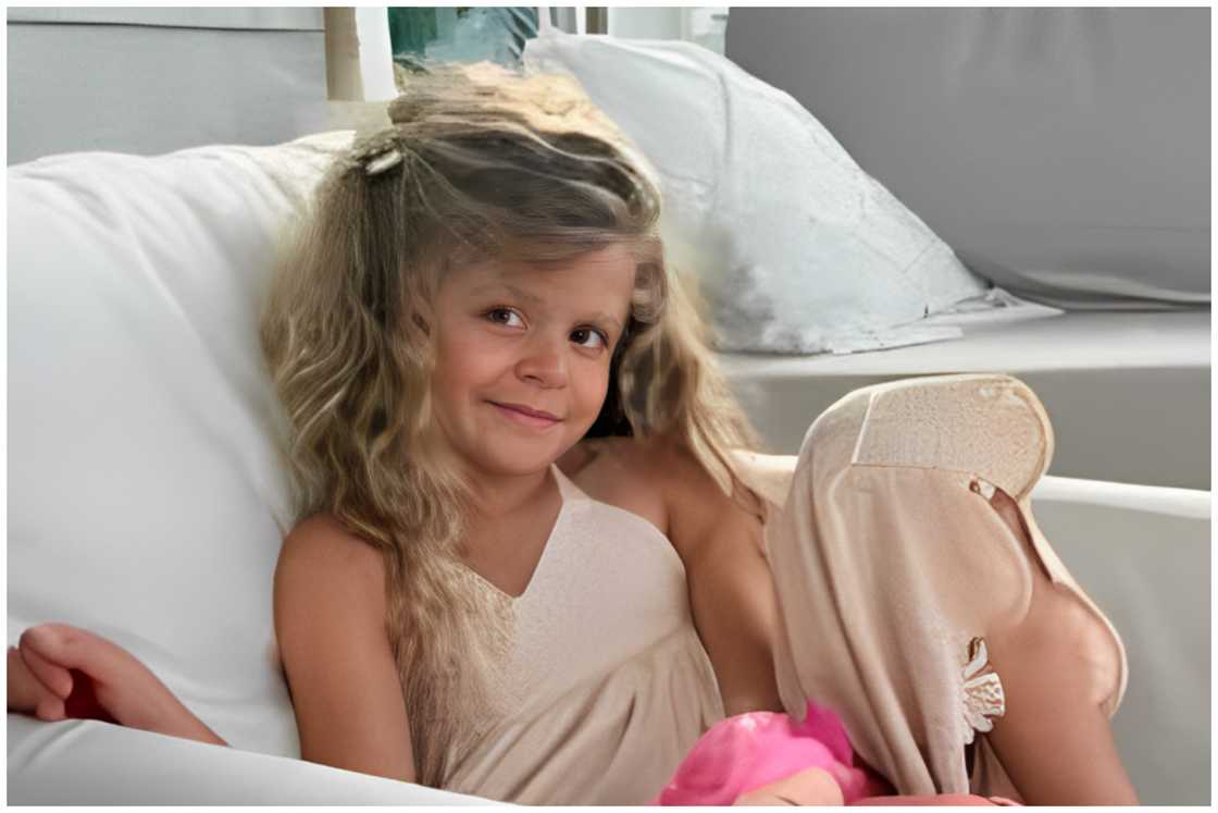 Lennon Love Akins sitting on a couch Lennon Love Akins sitting on a couch