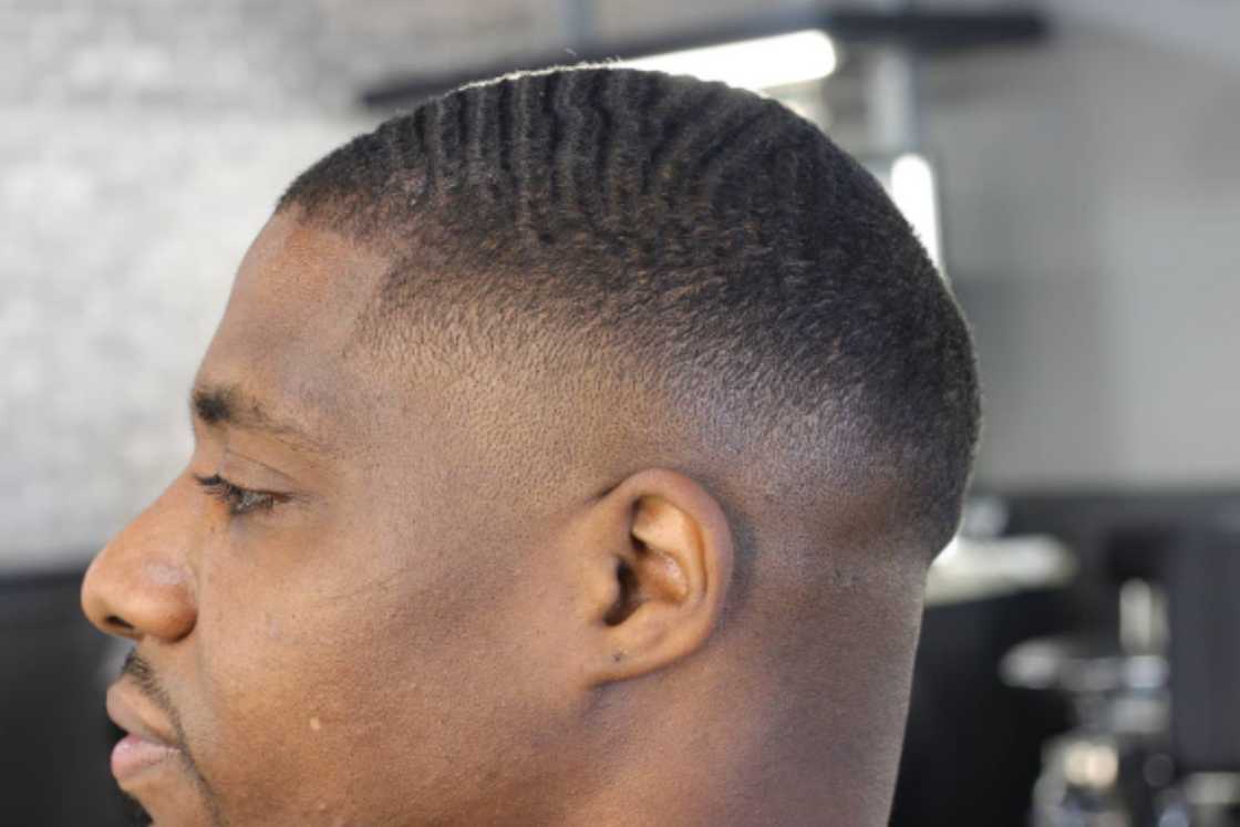 An African man with a low bald fade haircut An African man with a low bald fade haircut