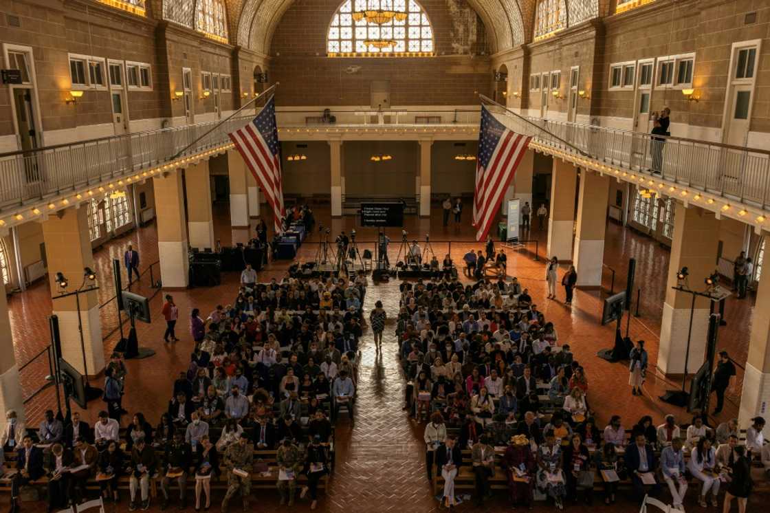 New US citizens attend a naturalization service on Ellis Island New US citizens attend a naturalization service on Ellis Island