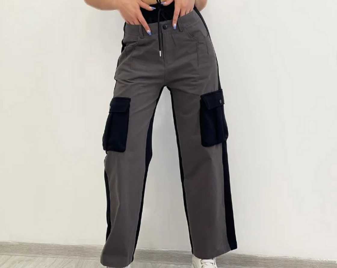 A woman in chocolate designer cargo pants A woman in chocolate designer cargo pants