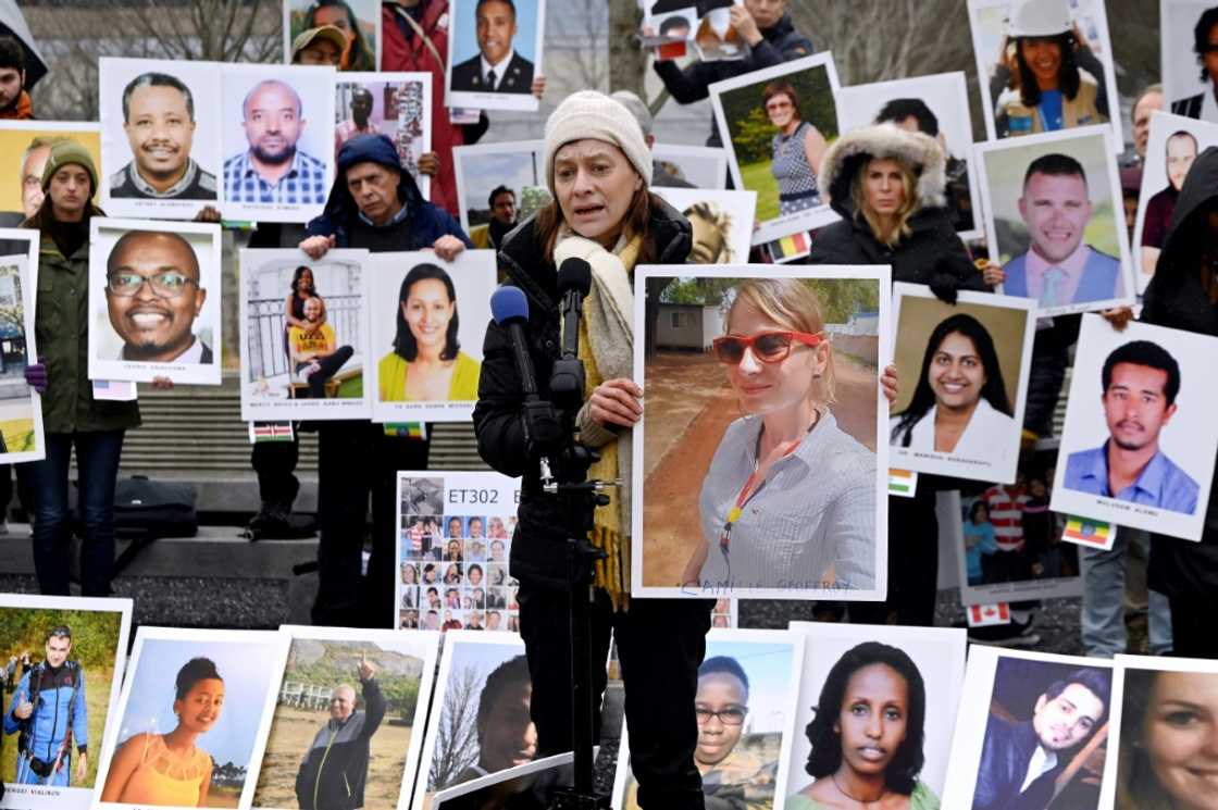 Families of victims of the March 10, 2019, crash of a Boeing 737 MAX airplane in Ethiopia hold up photos of the dead during a protest in Arlington, Virginia Families of victims of the March 10, 2019, crash of a Boeing 737 MAX airplane in Ethiopia hold up photos of the dead during a protest in Arlington, Virginia