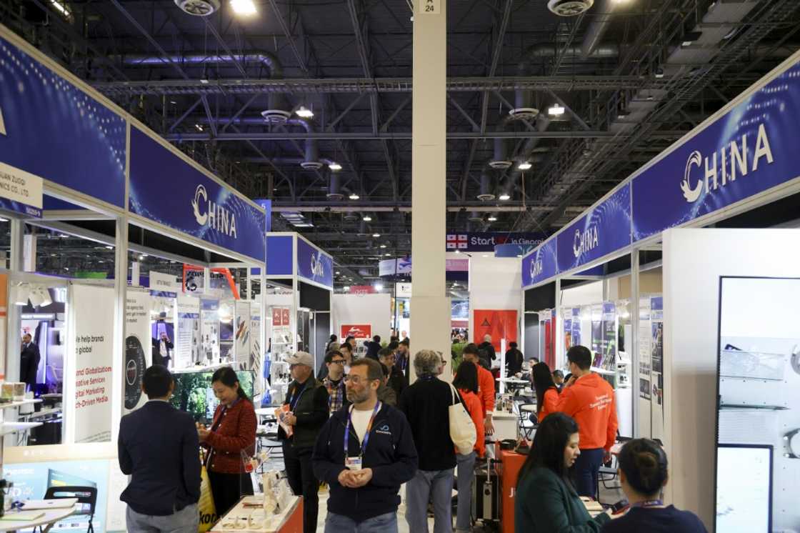 Attendees walk past a row of Chinese businesses at the annual Las Vegas tech show CES in January, 2024 Attendees walk past a row of Chinese businesses at the annual Las Vegas tech show CES in January, 2024
