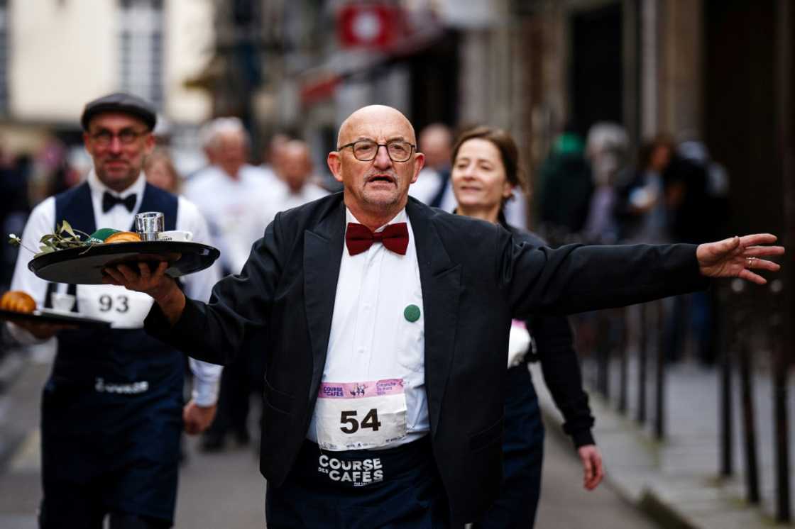 Waiters had to carry a tray of croissant, coffee and water around the course Waiters had to carry a tray of croissant, coffee and water around the course