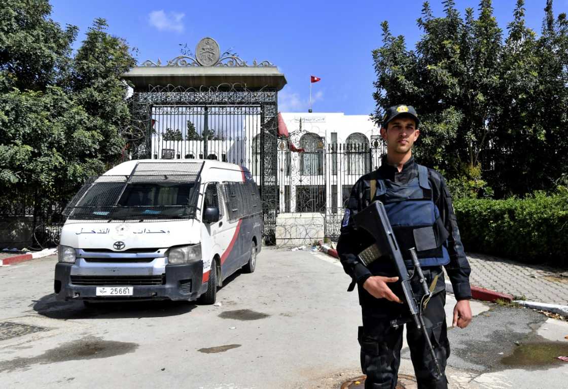 A Tunisian security guard stands guard outside parliament in Tunis on March 31, 2022