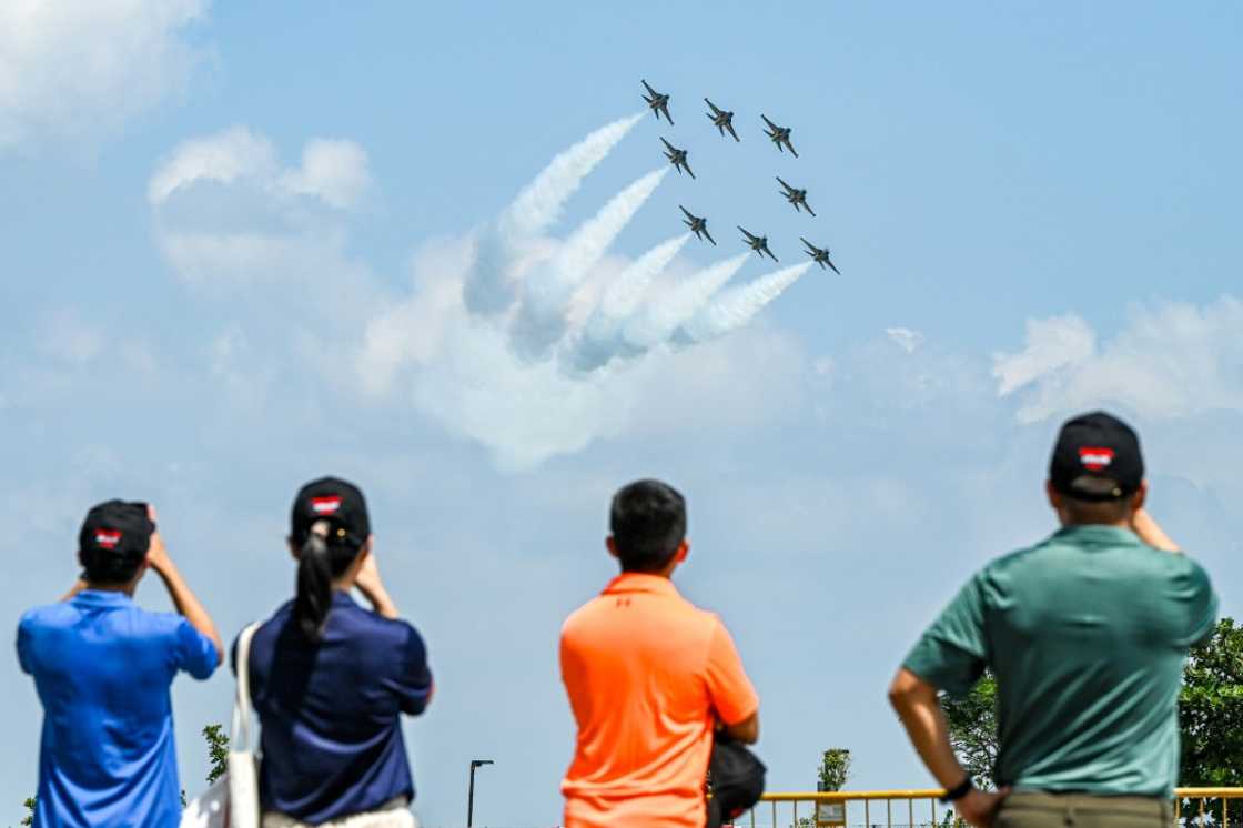 Spectators watch members of South Korea's 'Black Eagle' aerobatics team performing during a preview of the Singapore Airshow in Singapore on February 18, 2024 Spectators watch members of South Korea's 'Black Eagle' aerobatics team performing during a preview of the Singapore Airshow in Singapore on February 18, 2024