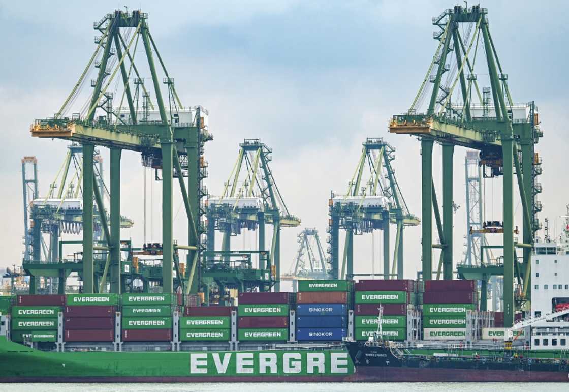 A vessel loaded with containers is docked at Pasir Panjang port terminal in Singapore. Exports from the city-state slid again in August as shipments to its biggest markets -- the US and China -- keep dropping