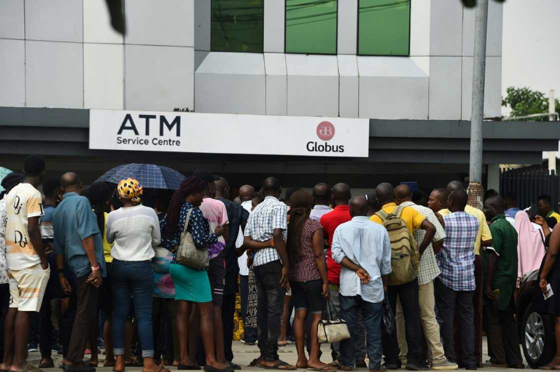Many Nigerians have been queueing for hours outside ATMs to try and get cash after a redesign of the local currency Many Nigerians have been queueing for hours outside ATMs to try and get cash after a redesign of the local currency