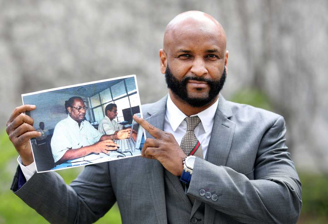 Baba Hydara, son of murdered Gambian journalist Deyda Hydara, with a photo of his father