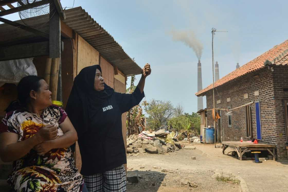 Local residents talk about air pollution during an interview with AFP near the Suralaya coal-fired power plant in Cilegon, in Indonesia's Banten province