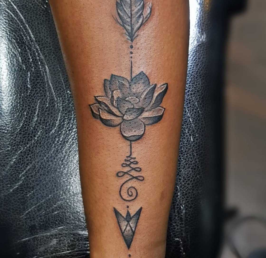 Arrow and lotus flower tattoo