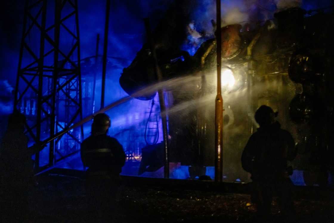 Ukrainian firefighters attempt to extinguish a fire at a power station in Kharkiv on September 11, 2022, following a missile strike