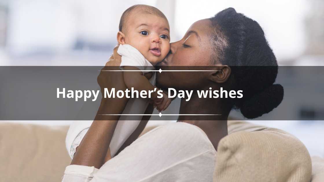 A beautiful young African American mother gently holds her infant daughter up in the air with both hands and kisses her cheek. A beautiful young African American mother gently holds her infant daughter up in the air with both hands and kisses her cheek.