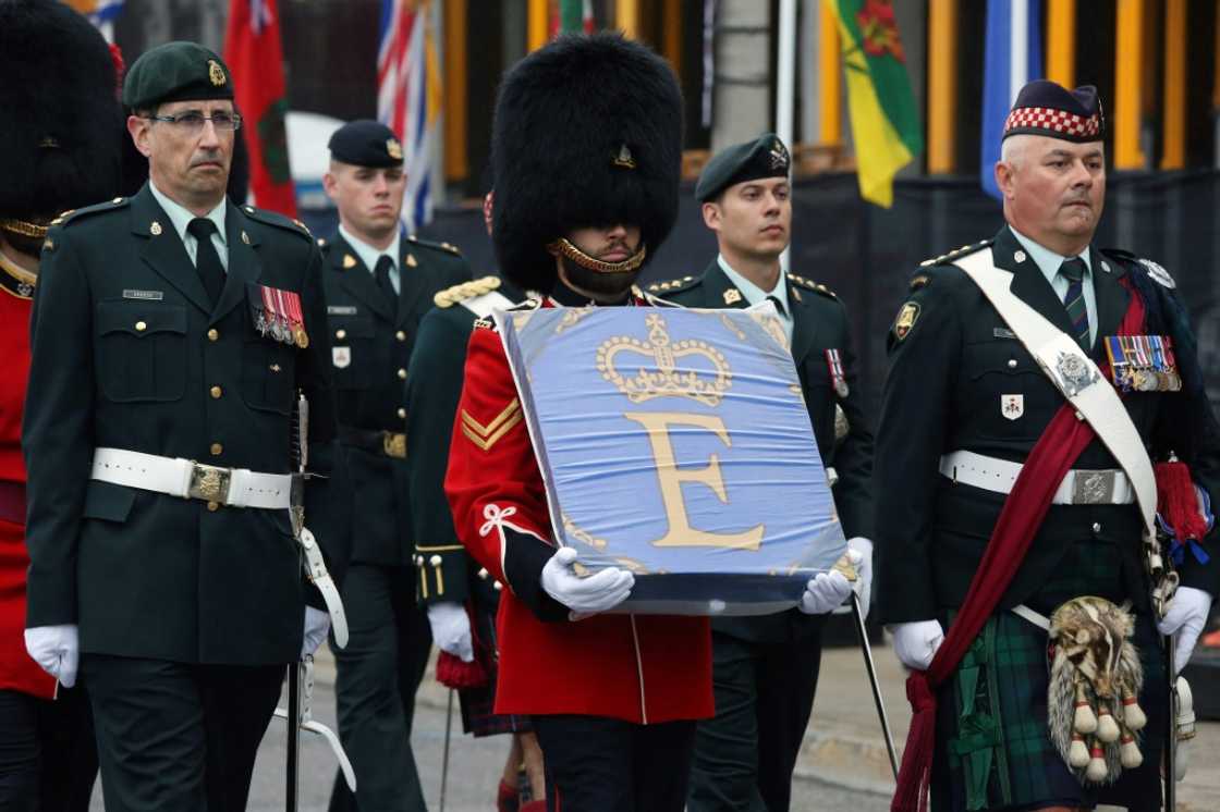 A member of the Governor General's Foot Guards carries the Queen Elizabeth Canadian flag during a memorial service for Queen Elizabeth II in Ottawa, Canada on Monday A member of the Governor General's Foot Guards carries the Queen Elizabeth Canadian flag during a memorial service for Queen Elizabeth II in Ottawa, Canada on Monday
