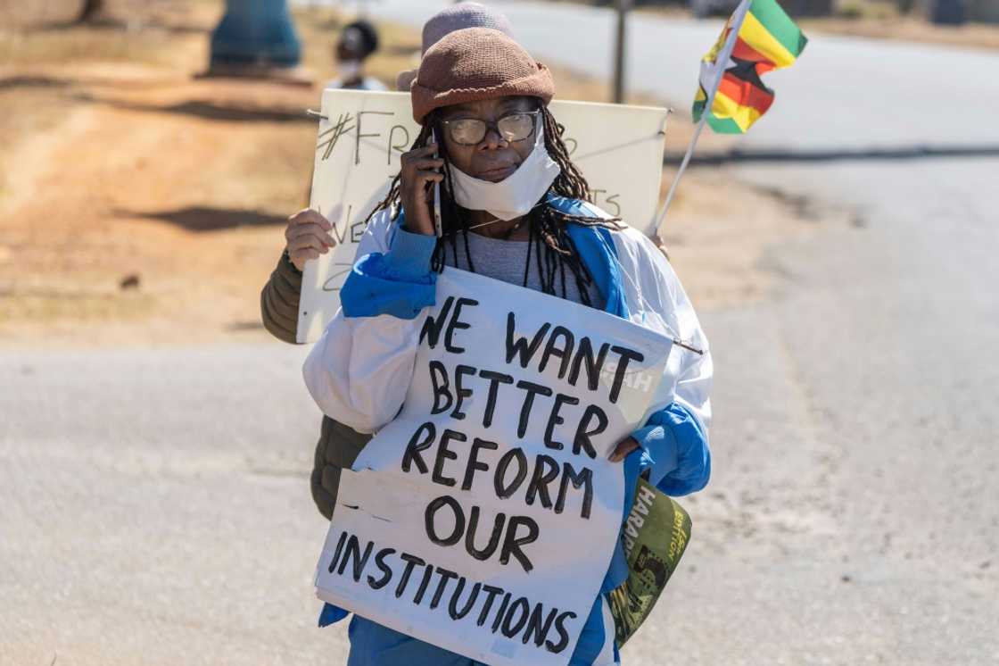 The feminist writer, here seen with her poster in July 2020, has said she will appeal the verdict