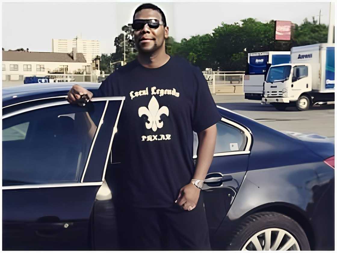 Curtis Bowles standing next to a car Curtis Bowles standing next to a car