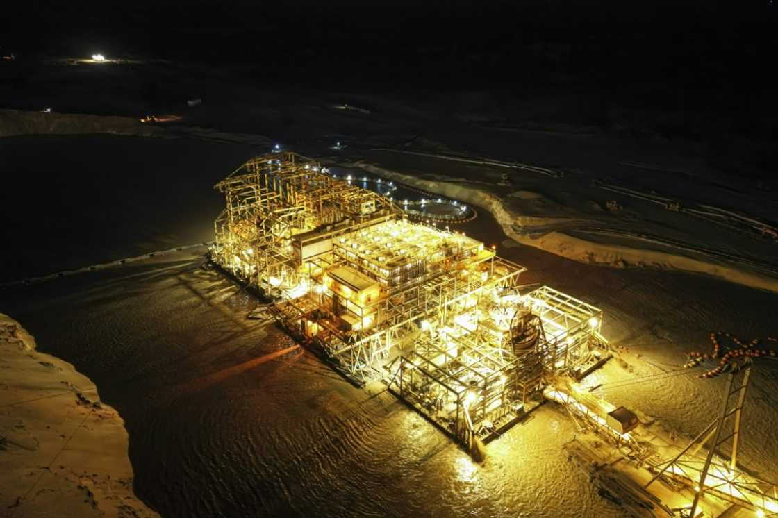 Hungry for zircon: The world's biggest mining dredger rig is so big it moves by being floated on its own lake Hungry for zircon: The world's biggest mining dredger rig is so big it moves by being floated on its own lake