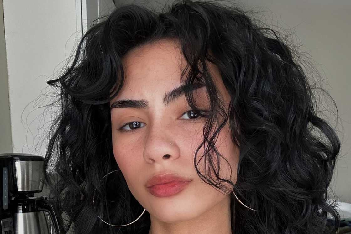 A lady with bulky wavy hair A lady with bulky wavy hair