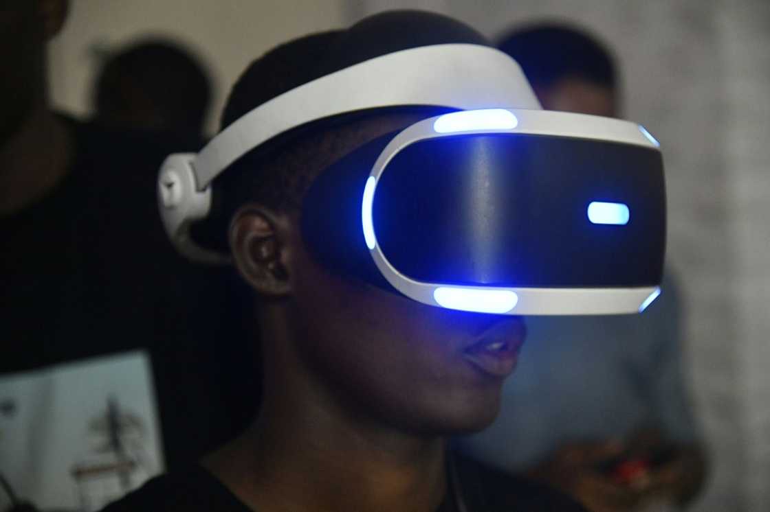 In the room drenched in purple and blue neon lights, players compete on state-of-the-art giant screens In the room drenched in purple and blue neon lights, players compete on state-of-the-art giant screens