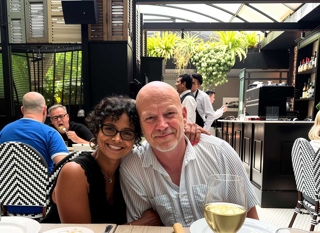Madison Alworth’s parents seated together at a modern restaurant.